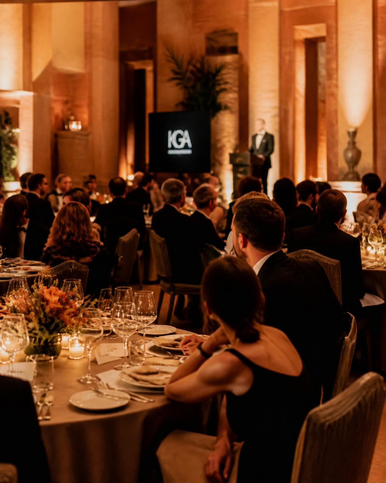 Luxury corporate gala dinner in a warm-lit ballroom by Aroona Events