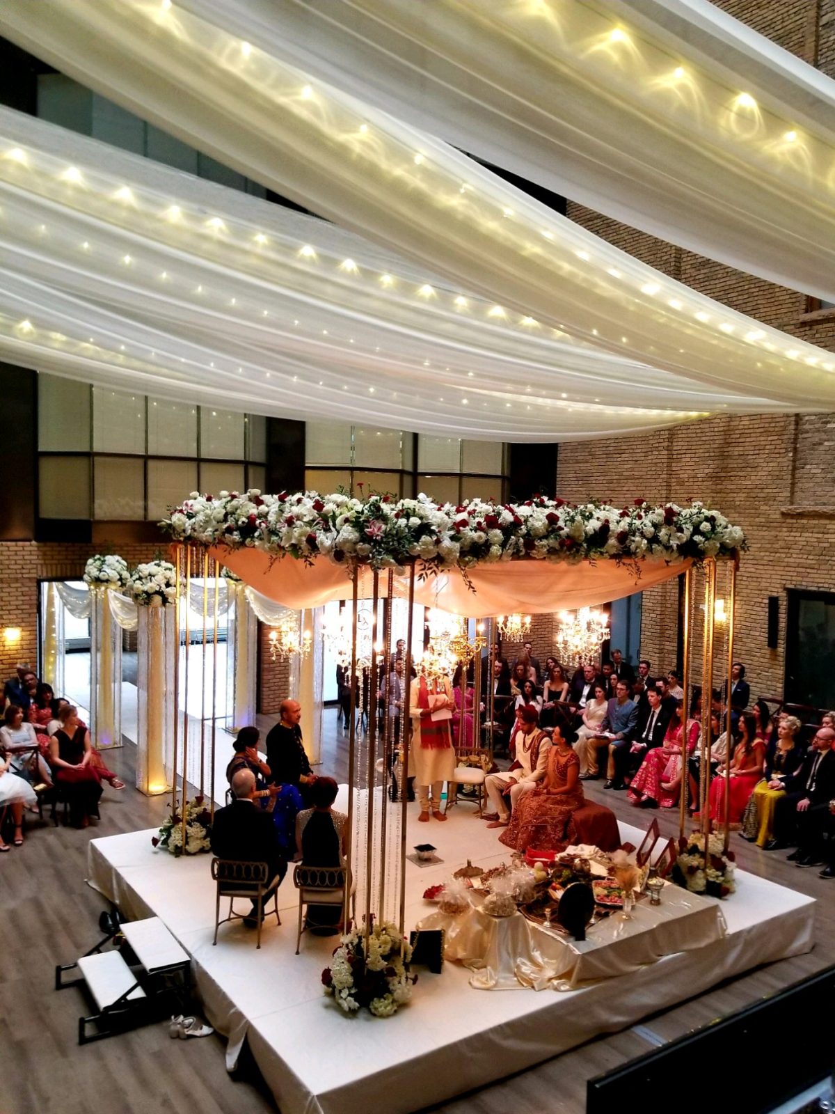 Historic Lumber Exchange ballroom reception with crystal candelabras and exposed brick